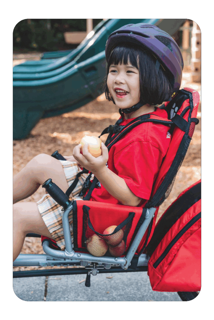 little girl in stroller with rockit apple
